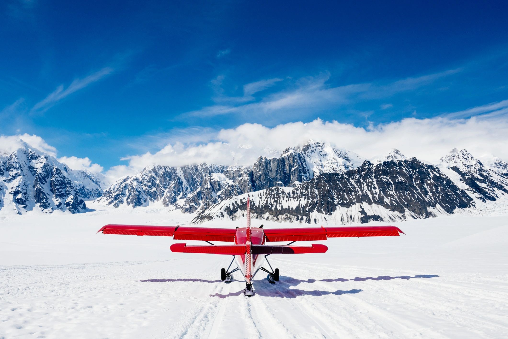 Alaska mountain landscape with ski plane taking off