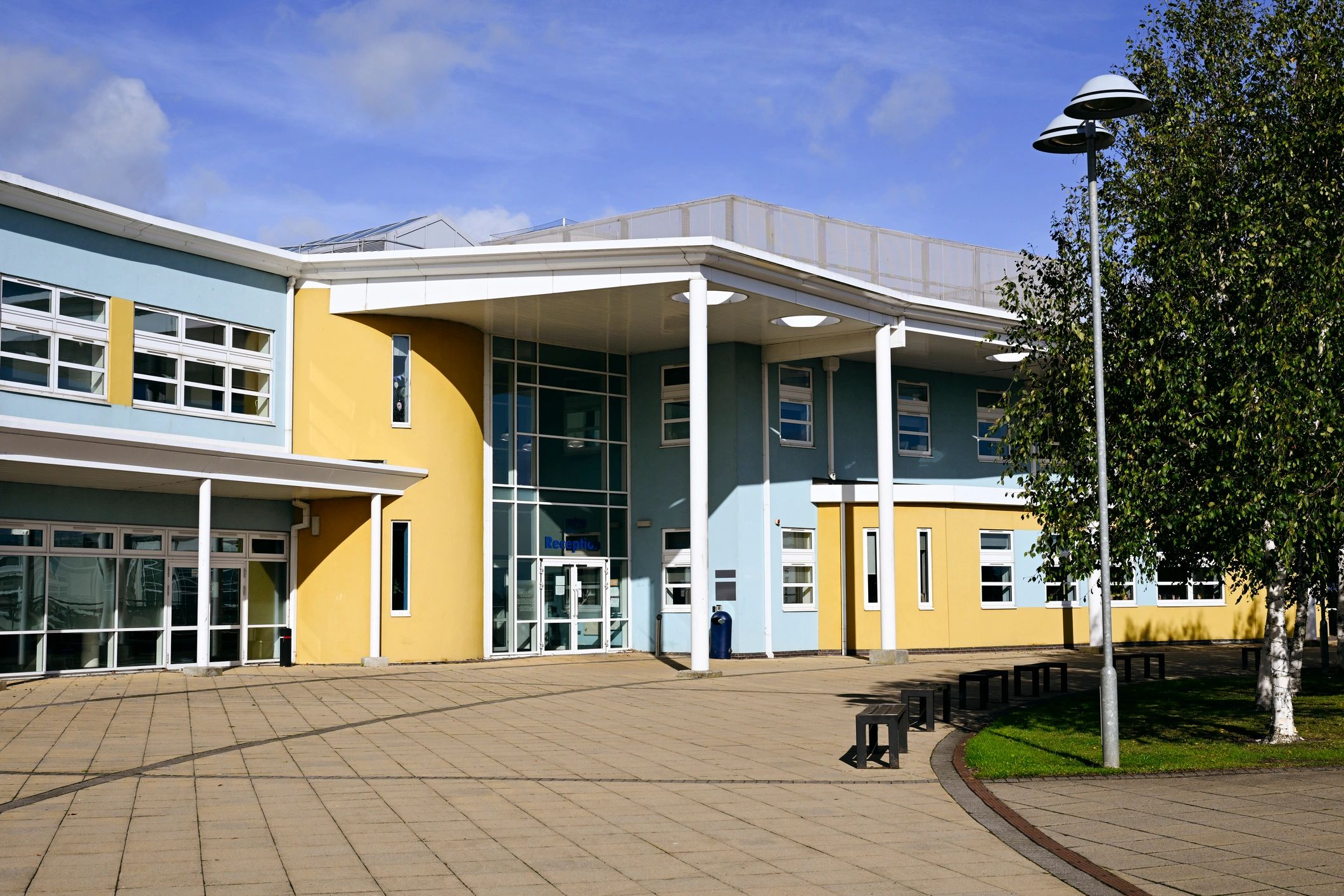 Building exterior with walkway and benches